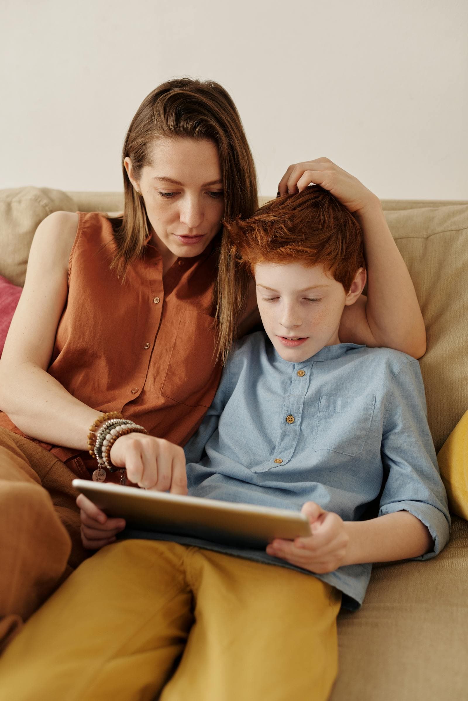 A parent and child using a tablet together